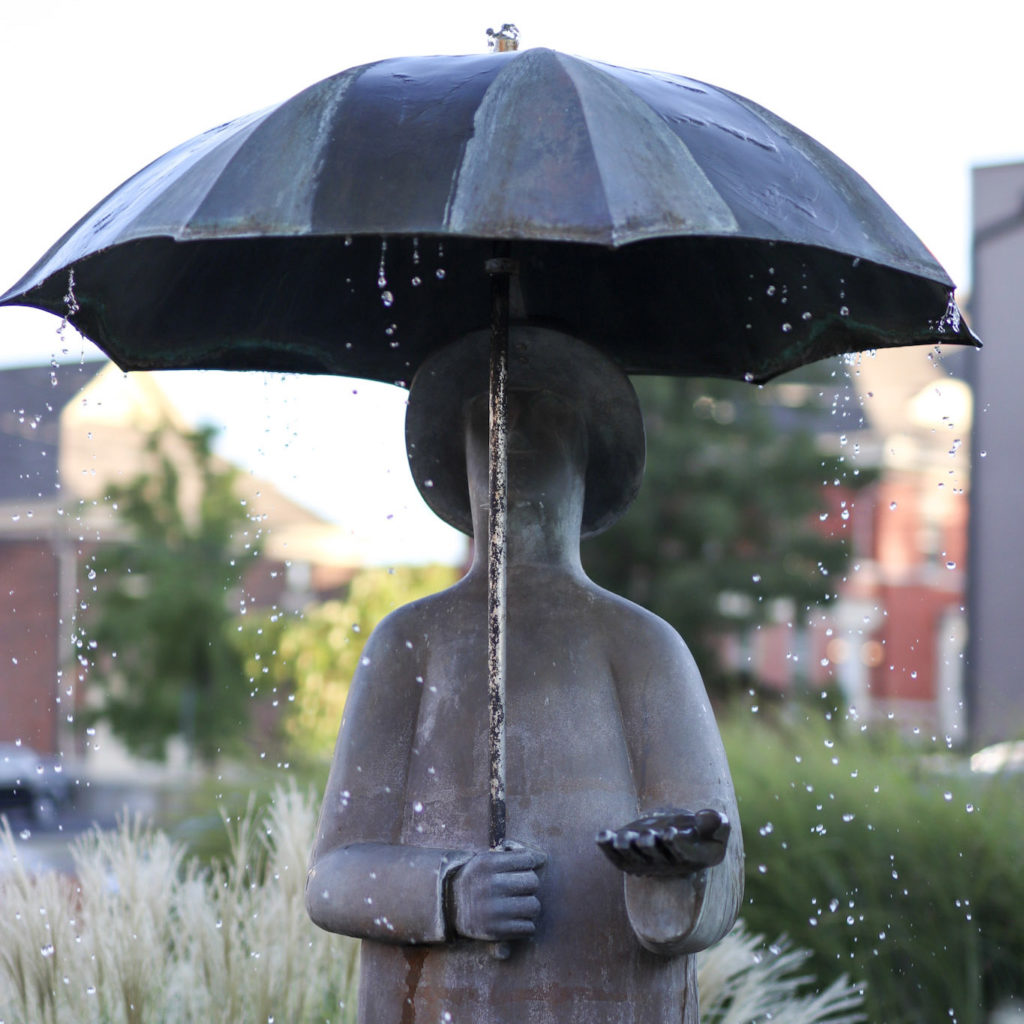 statute of a person holding an umbrella